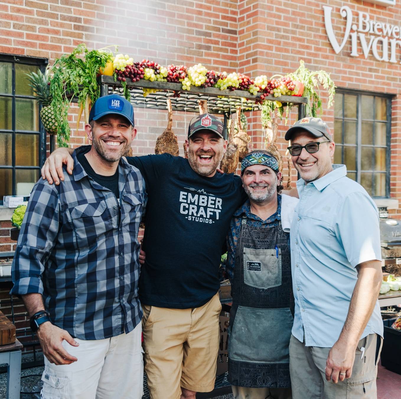 A group of brewers smile for a group photo outside brewery vivant
